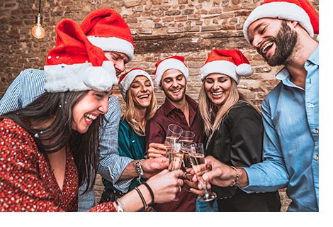 Company celebration with Christmas hats and champagne