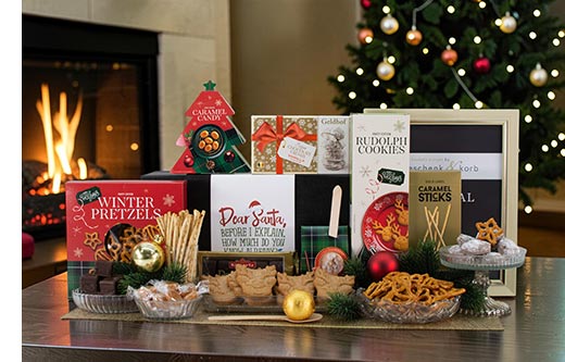 A beautifully unpacked Christmas gift basket presented on a festive table with holiday decorations.